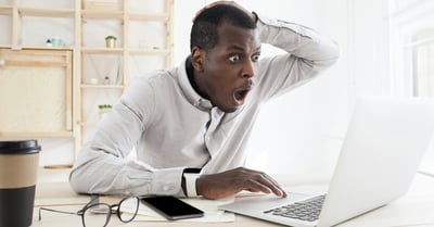 customer looking unpleasantly shocked at some news on their computer