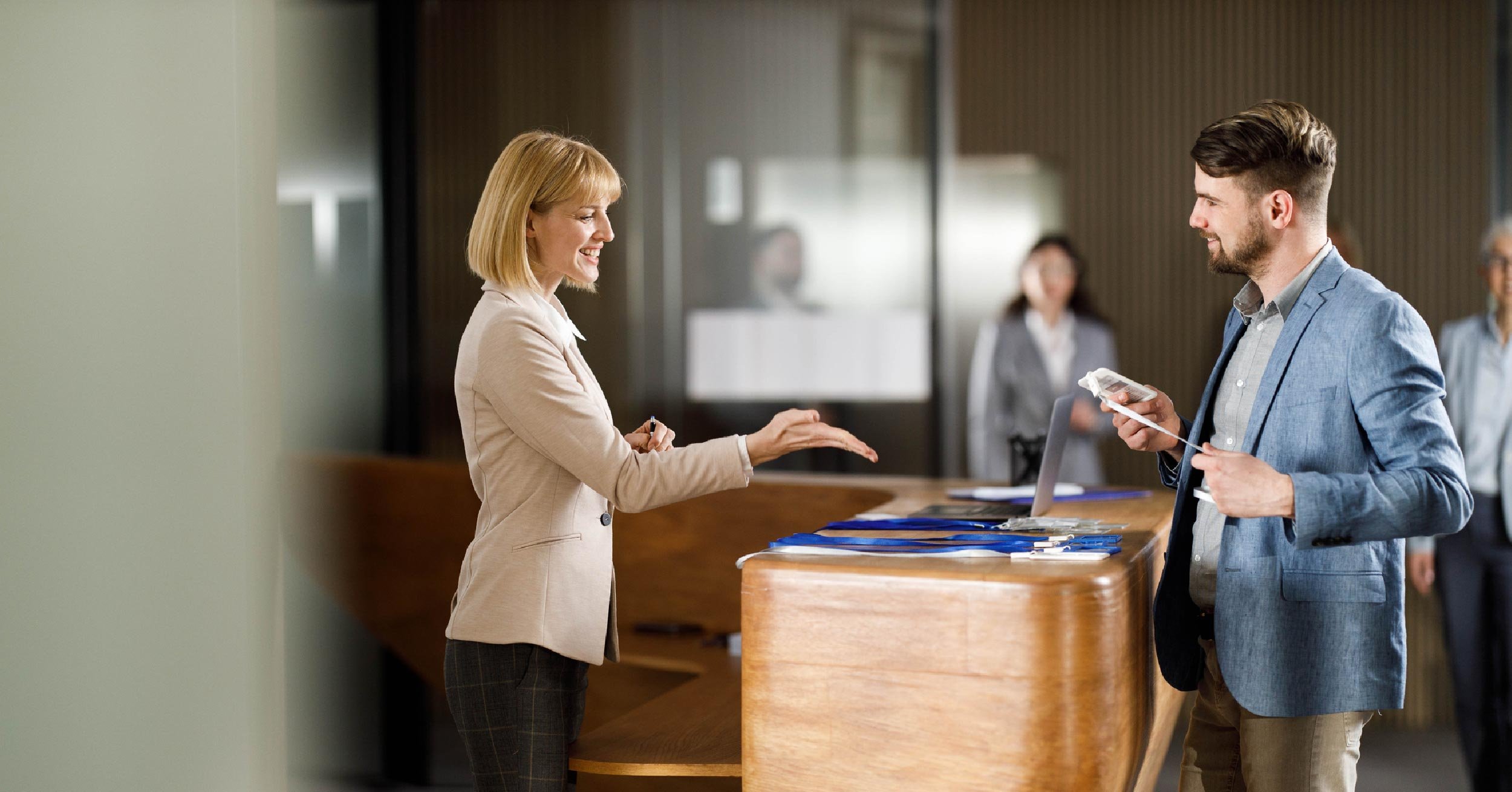 Man checking into corporate lobby