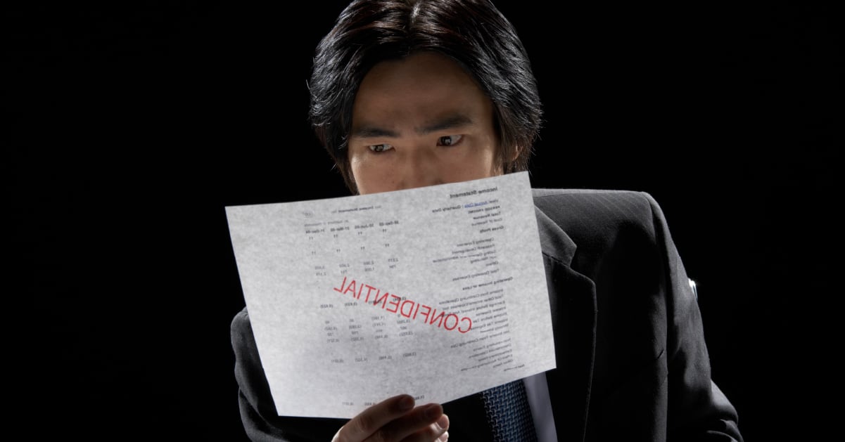 Person holding confidential paper