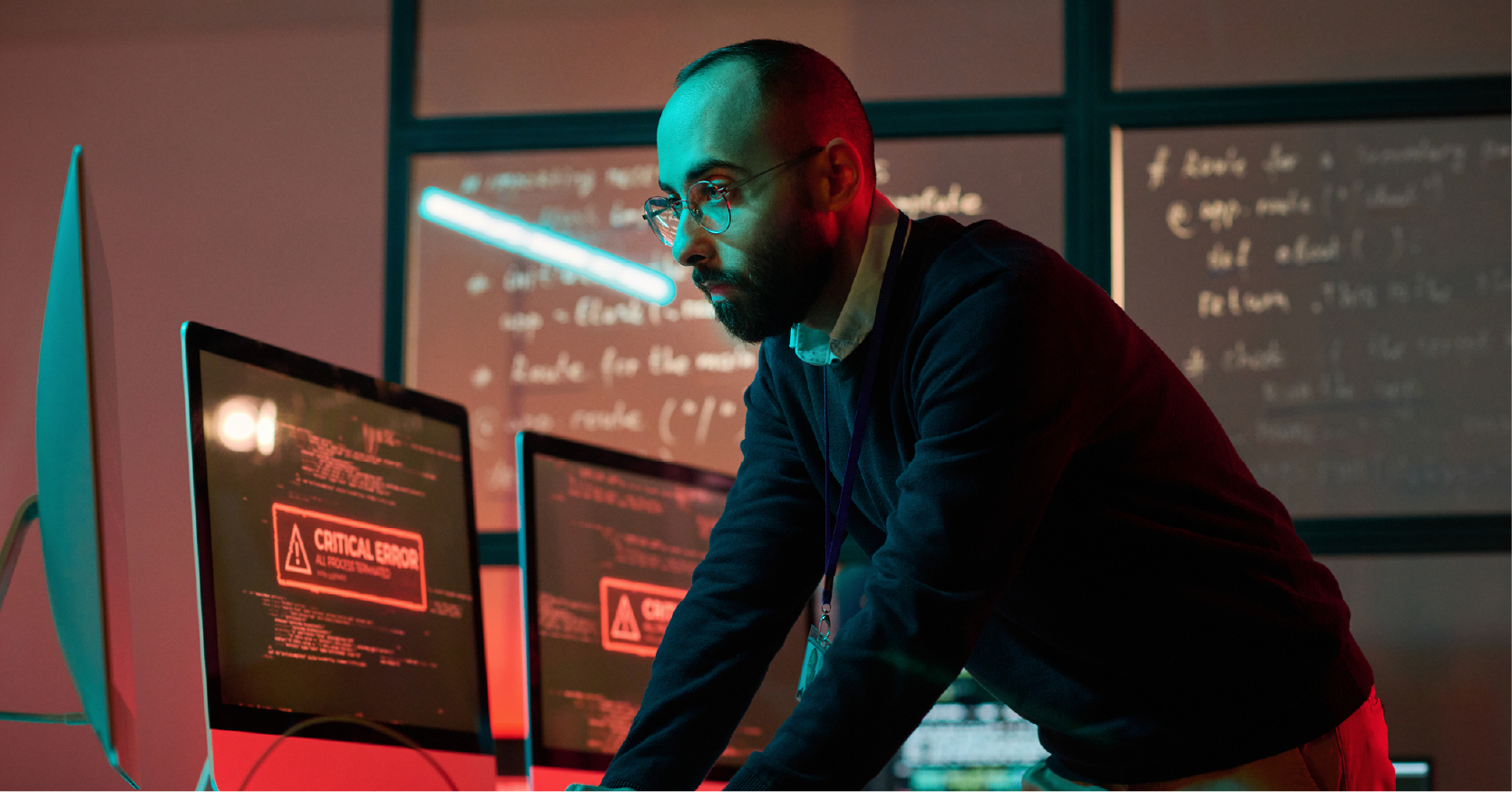 A male cybersecurity pro responds to a critical error on his computer screen.