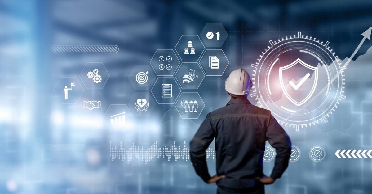 A worker looks over a digitized depiction of manufacturing cybersecurity basics