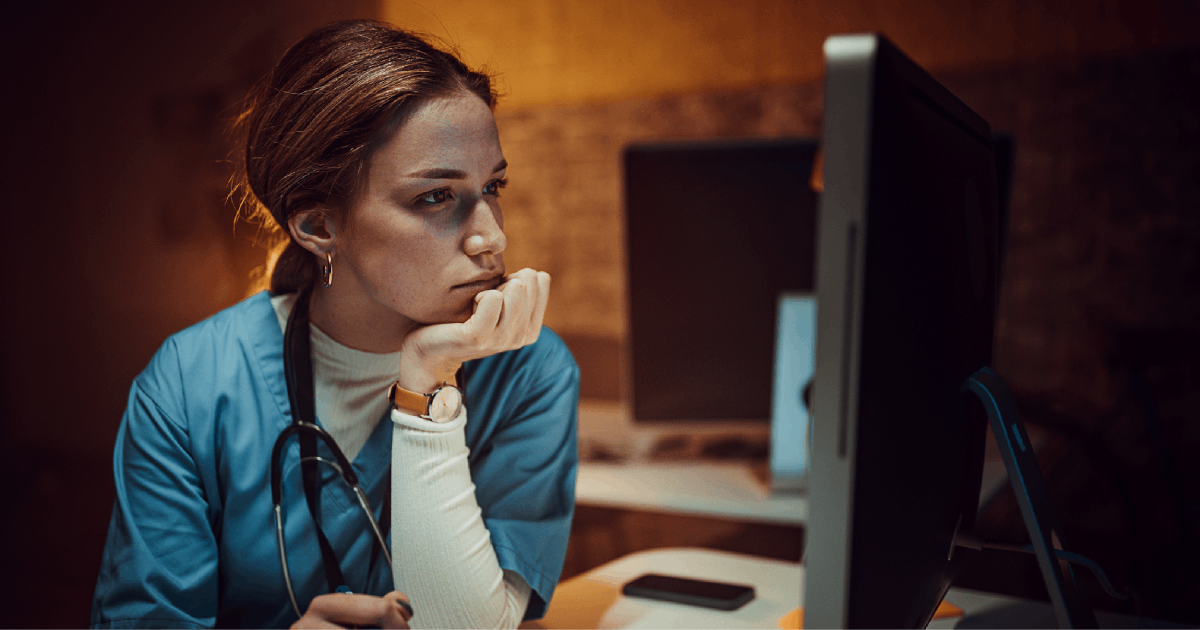 A long-term care worker uses a computer.
