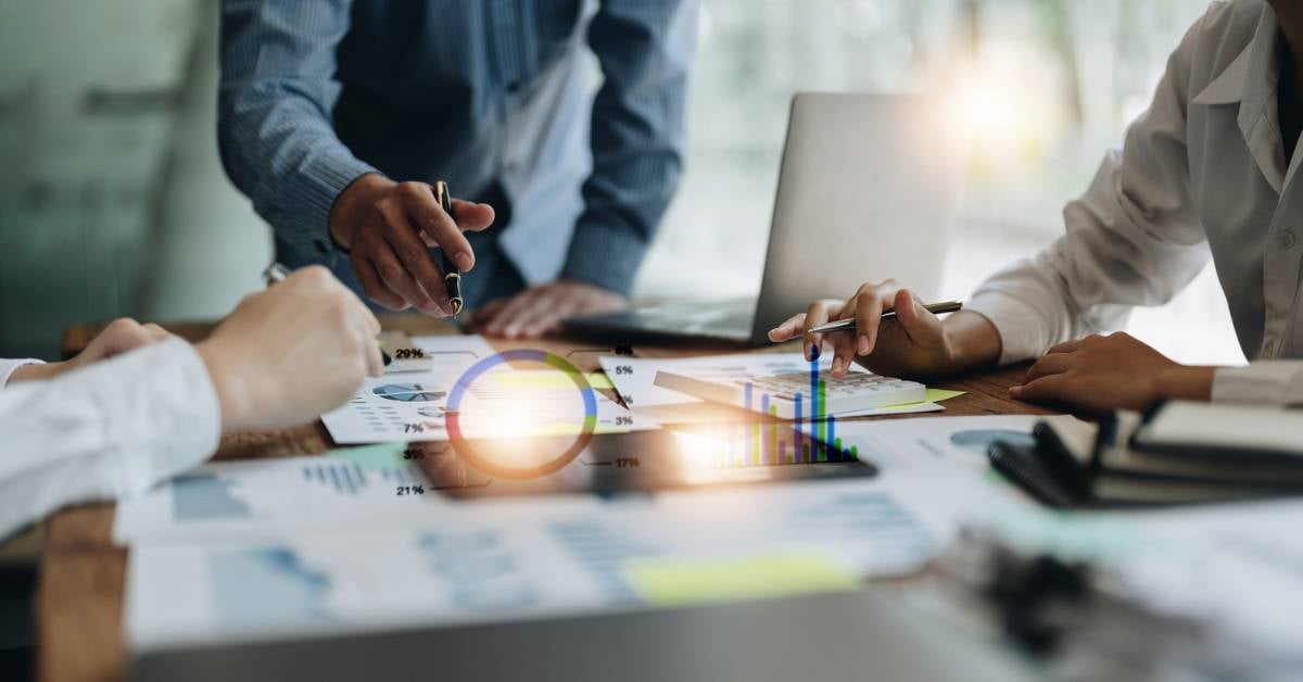 A business team meets to plan a large project.