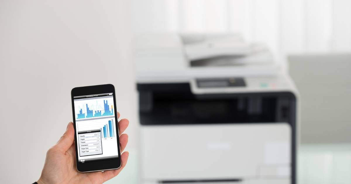 A-closeup-of-an-employee-using-their-cell-phone-to-initiate-printing