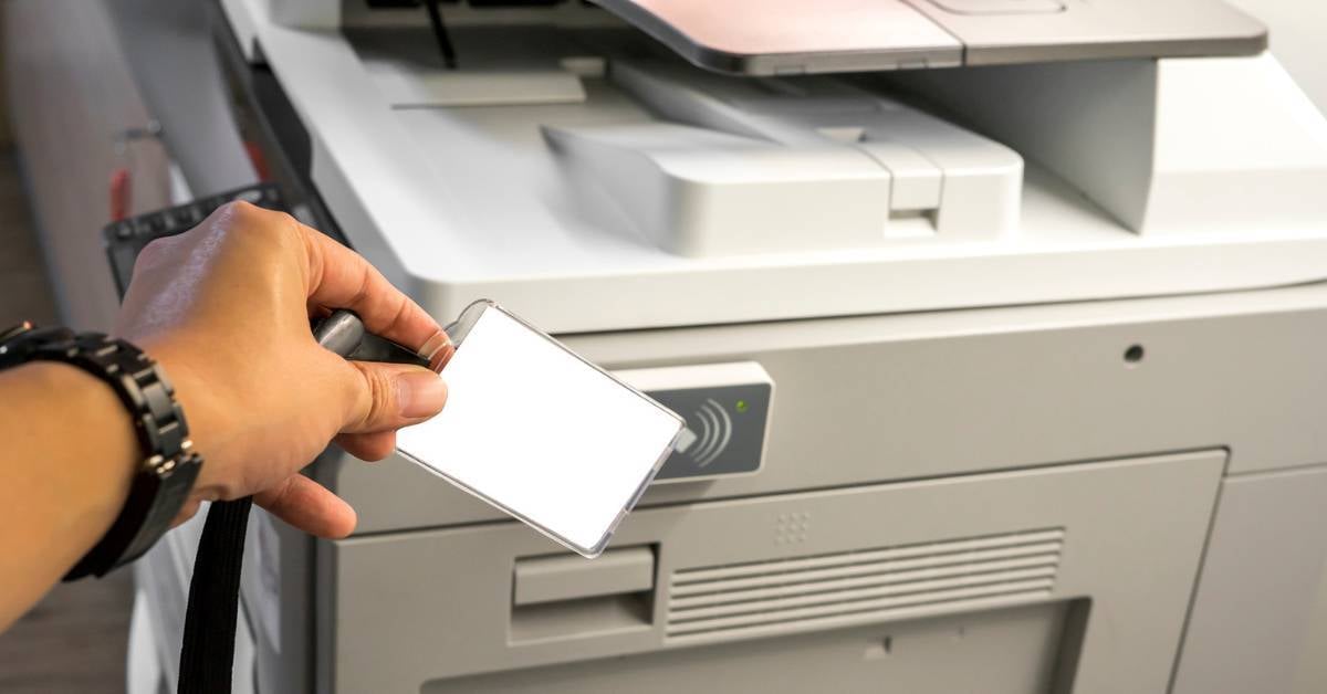 An-employee-verifies-their-identity-at-a-printer-for-secure-print-release