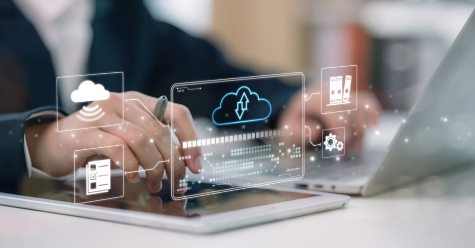 A closeup on a worker's hands with a digitized depiction of cloud storage.
