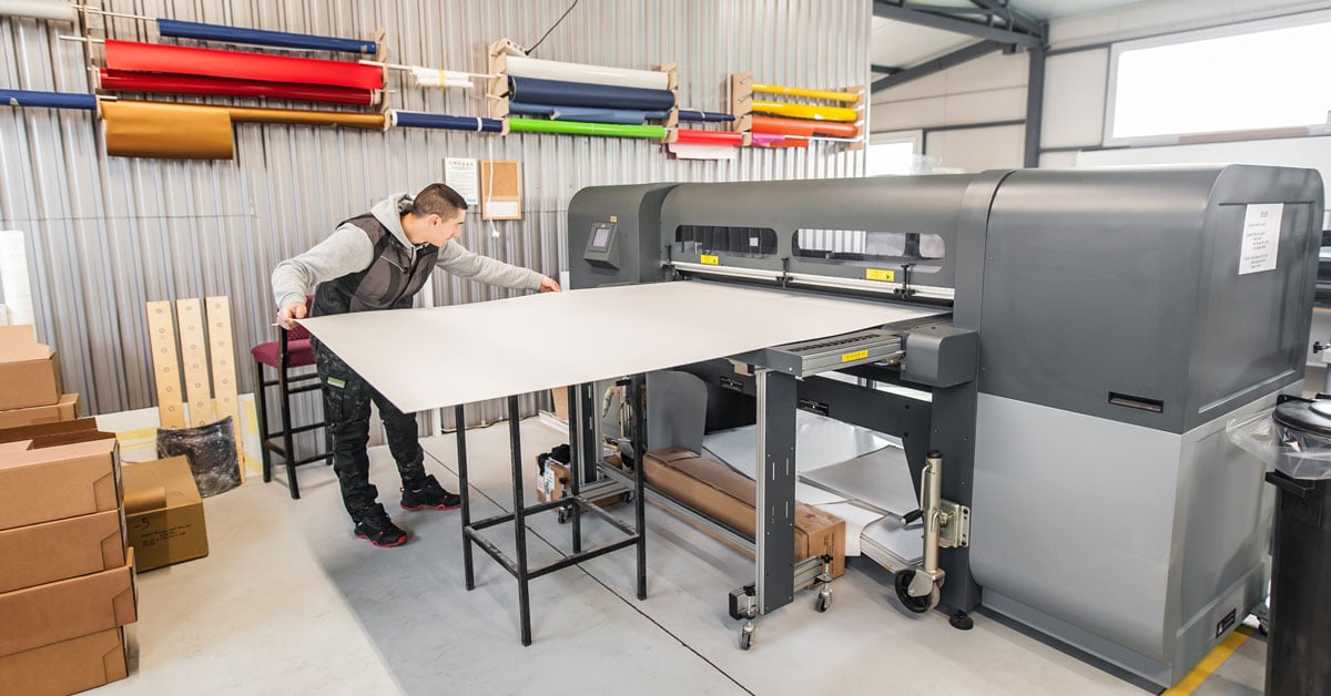 A professional printer prints on a rigid substrate.