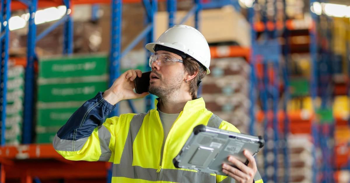A manufacturing employee uses communication tools.