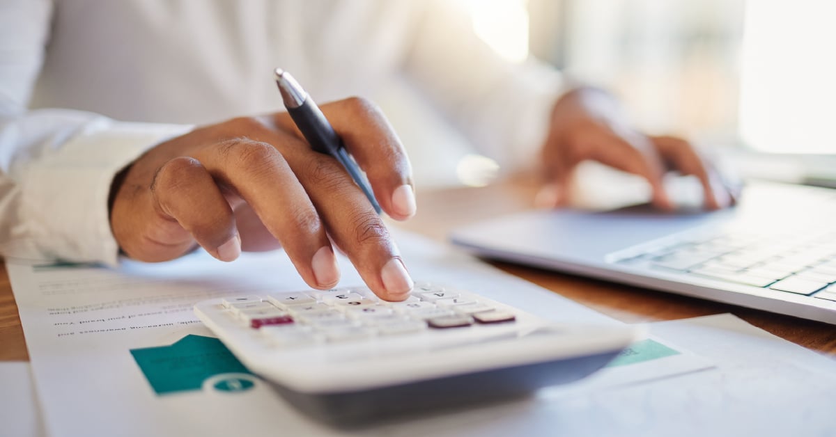 A closeup on an employee using a calculator.