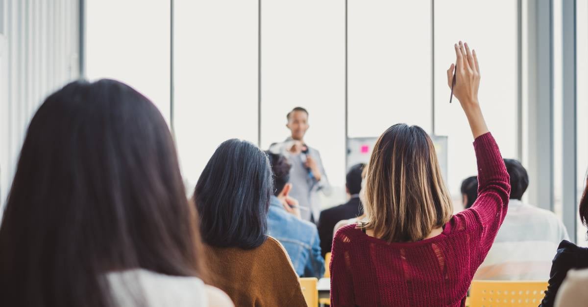 A group of adults listening to a presentation.