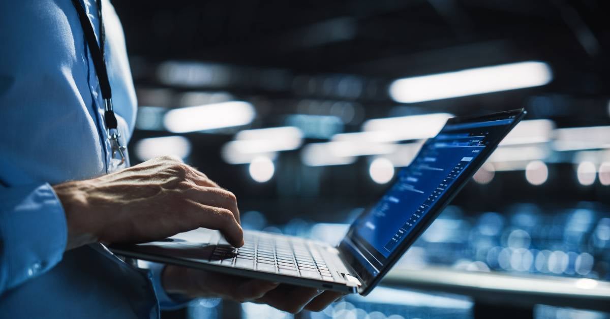 An IT professional using their laptop.