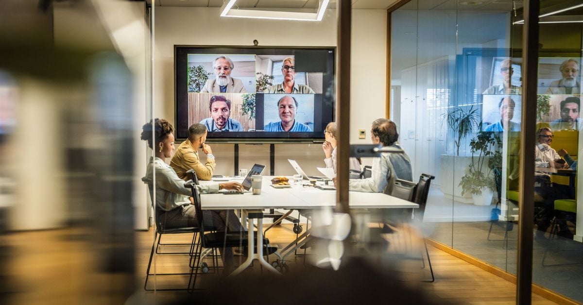 A hybrid work environment having a meeting.