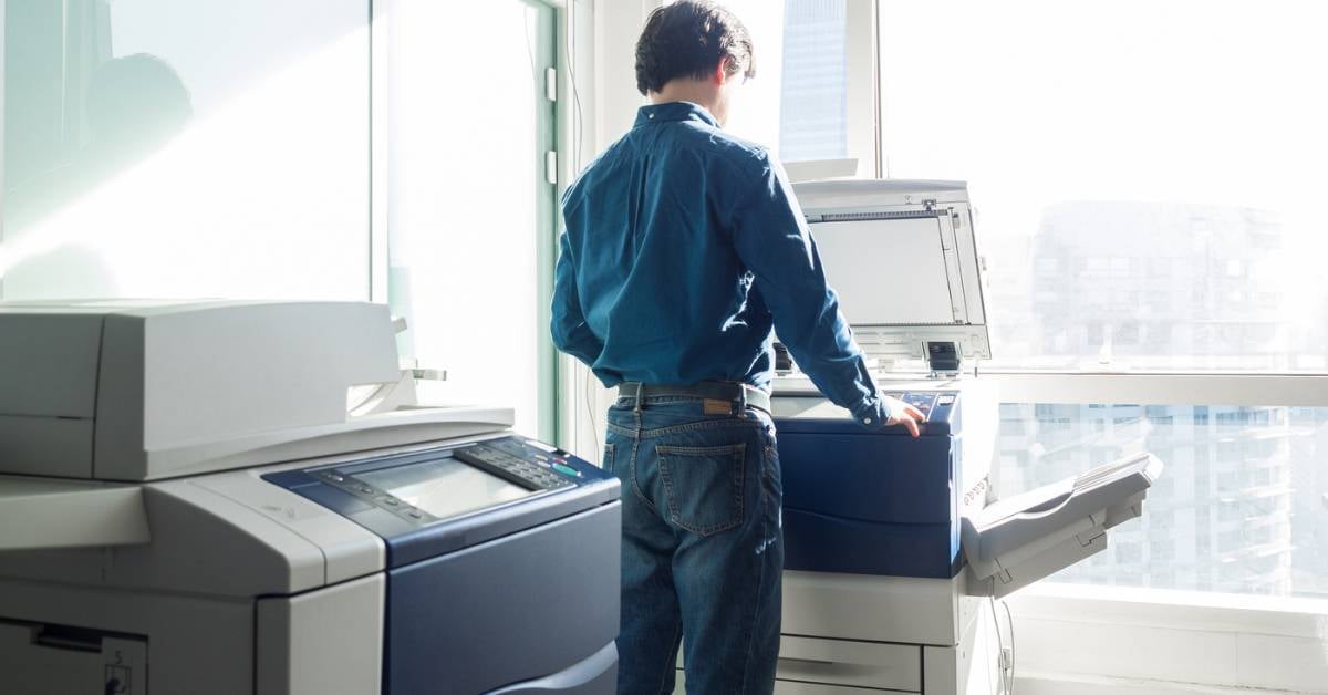 A-worker-uses-a-printer-against-a-sunny-window
