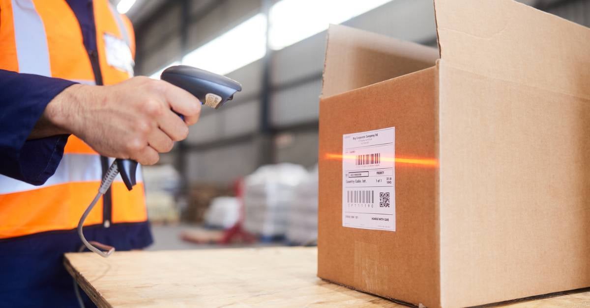 A-warehouse-employee-scans-a-box-with-label