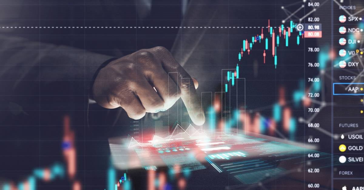 A digitized depiction of stock prices-superimposed over an executive using a tablet.