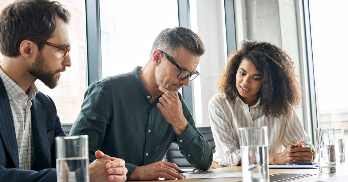 Three executives discuss an upcoming initiative.