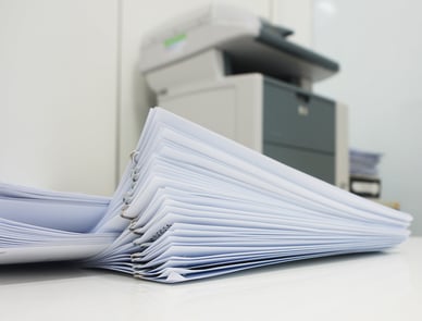 stack of paper in front of printer
