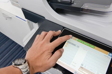 Employee using a digital printer office copy machine