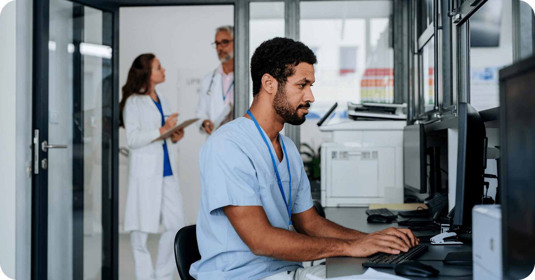 A healthcare worker working with a computer in a regional medical center.