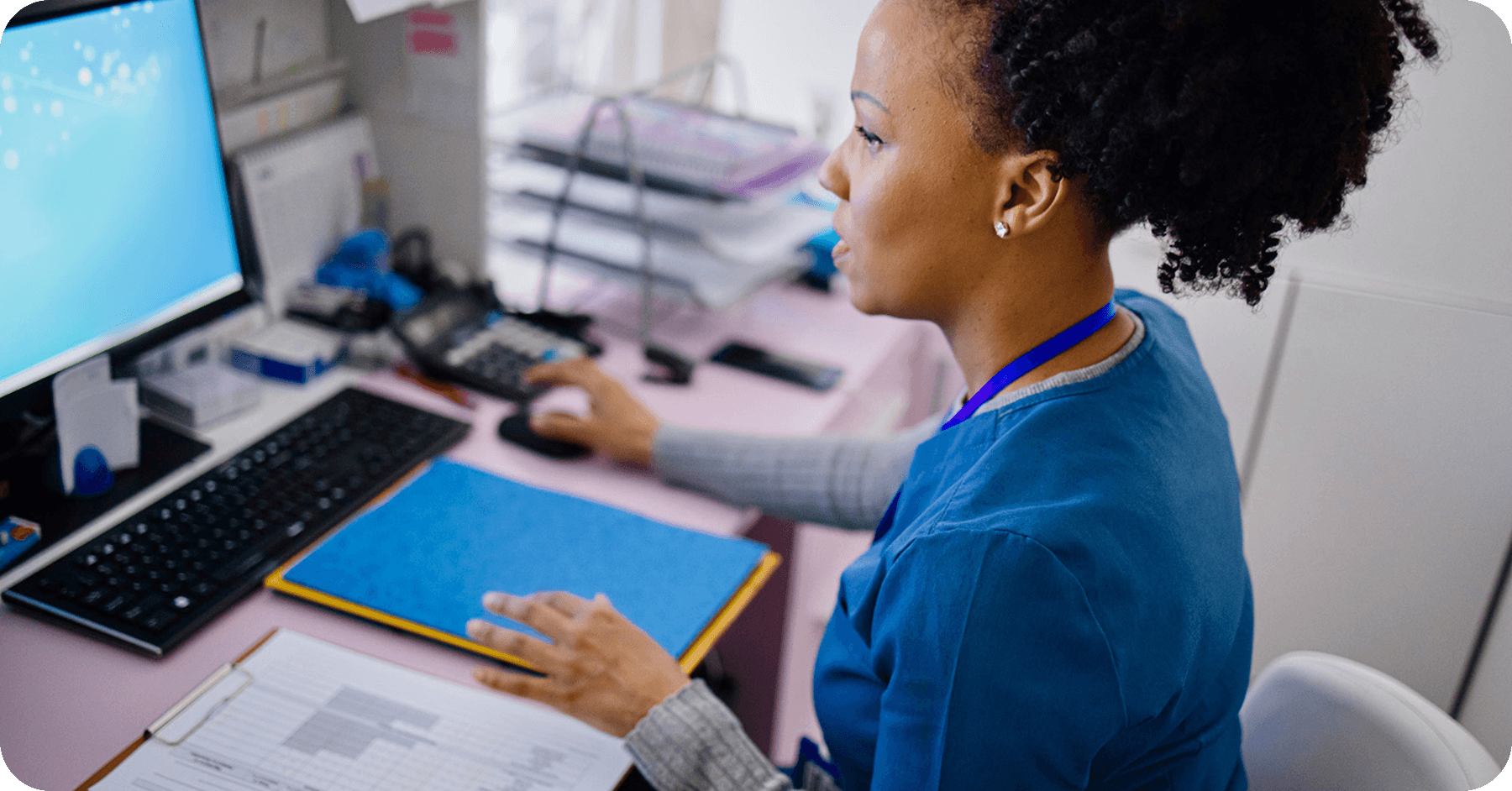 A nurse working with charts and files in a healthcare setting.