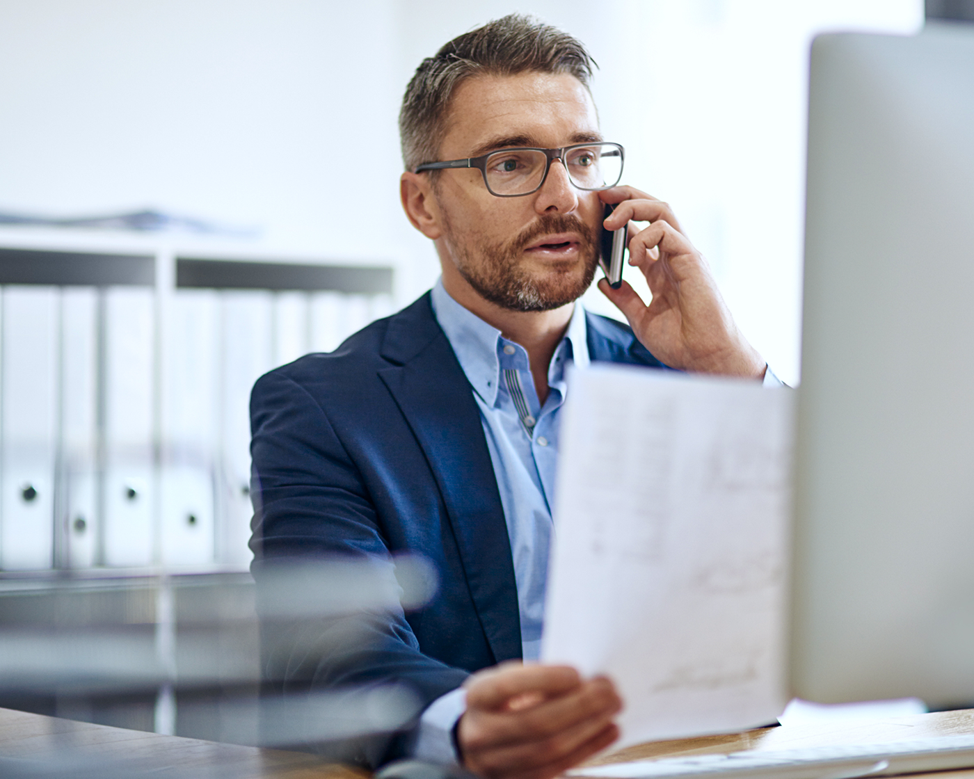 business-man-on-phone-infront-of-computer