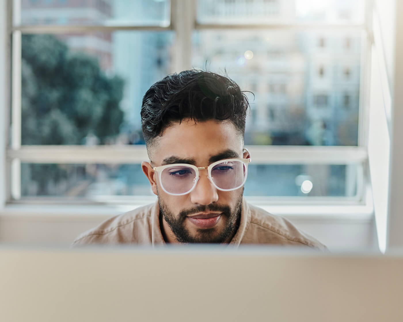 Job seeker researching job listings on a laptop.
