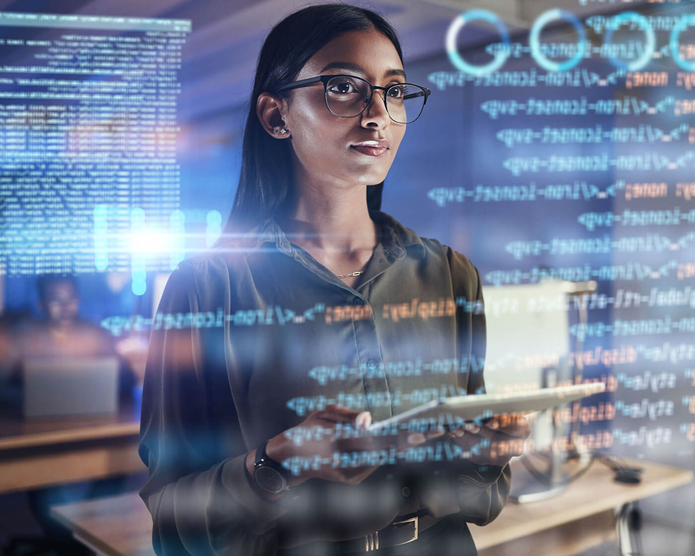 IT specialist reviewing code with a digital security overlay.