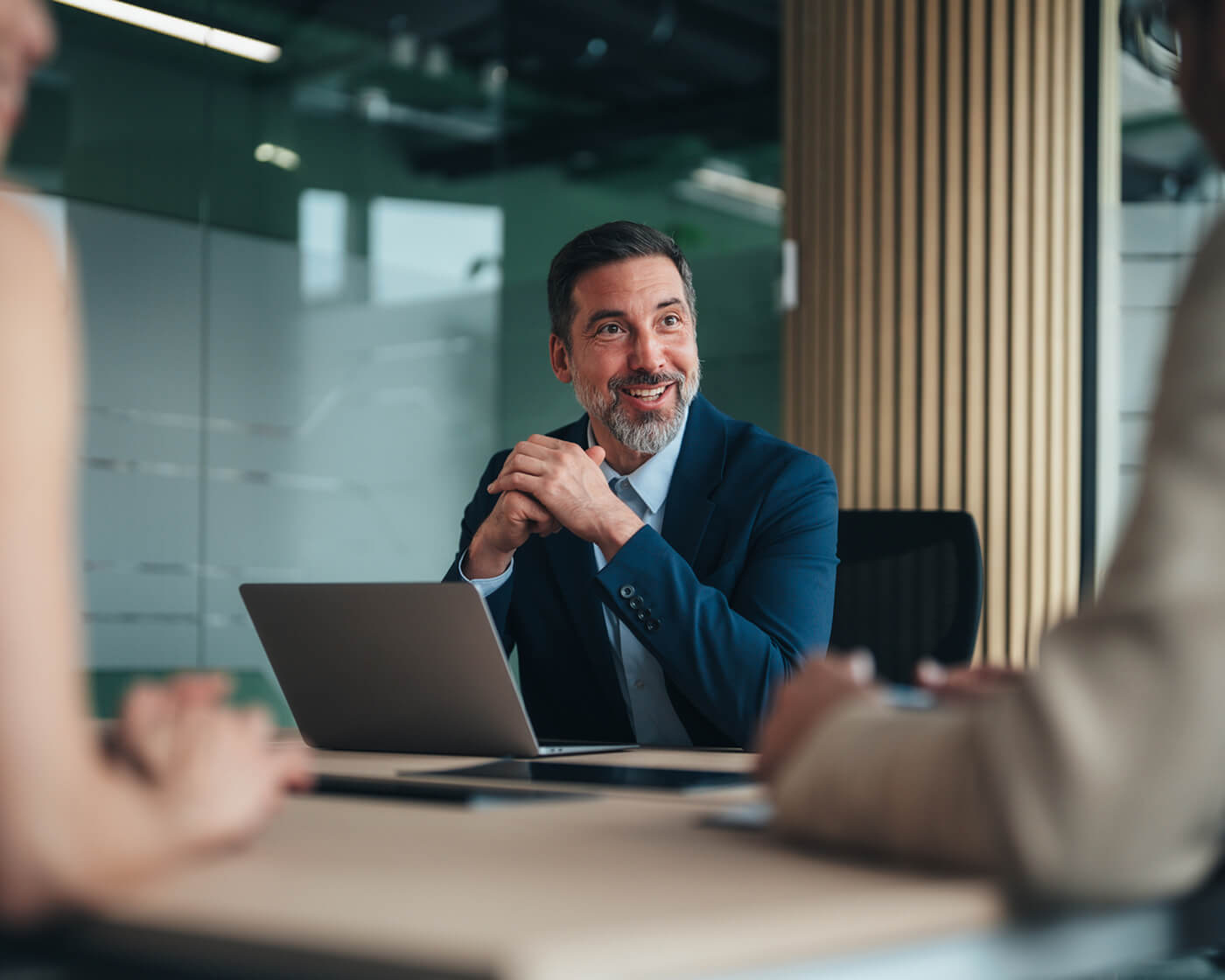 Businessman gesturing while on a call at his laptop in an office.