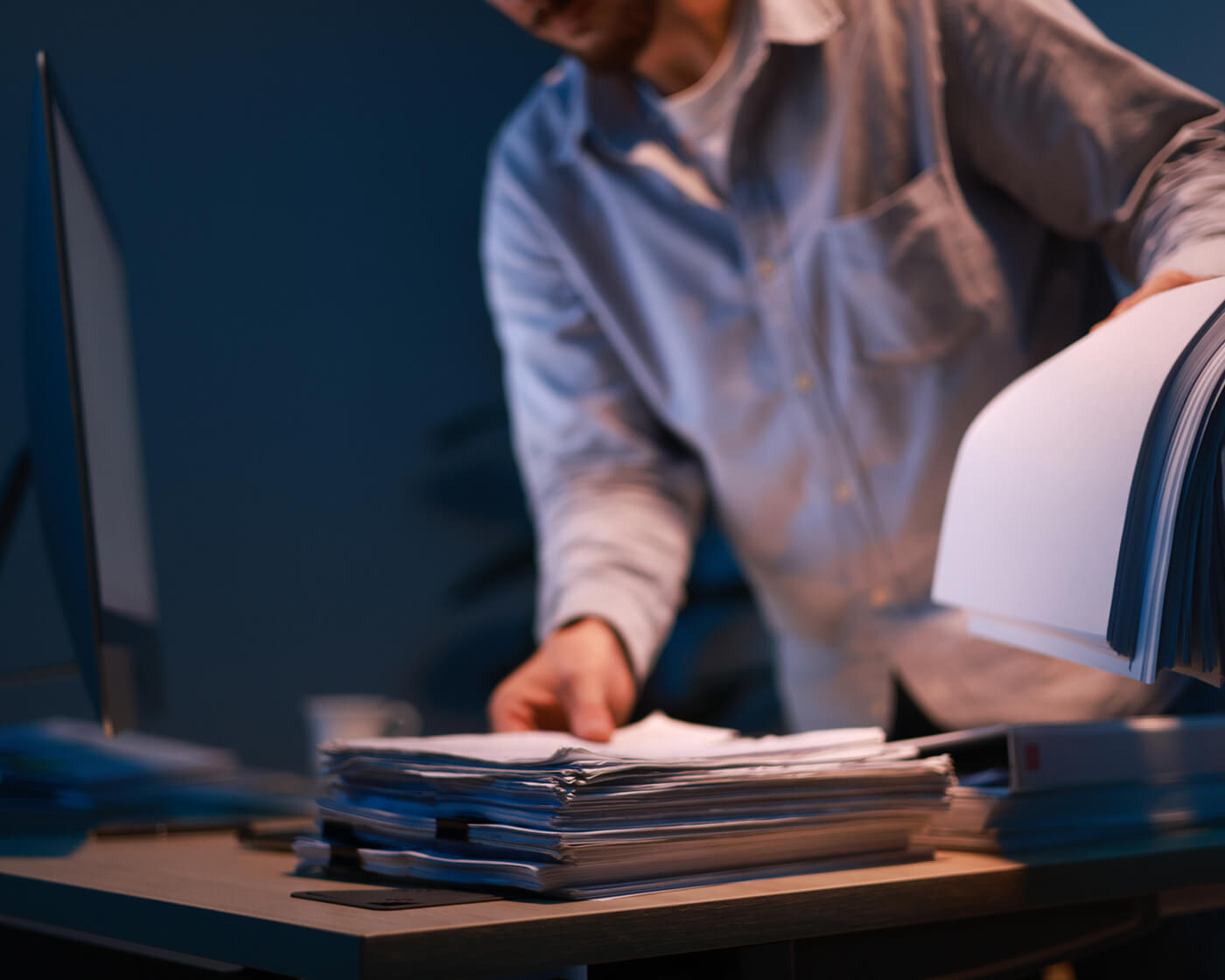 man-flipping-through-paper-stack