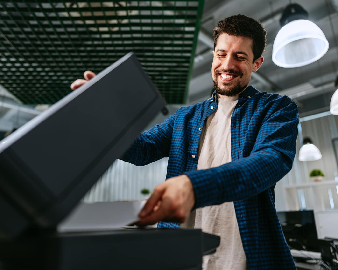 man-placing-paper-on-copier