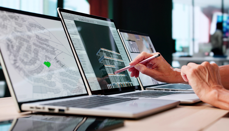 An architect reviewing a building design on a laptop.