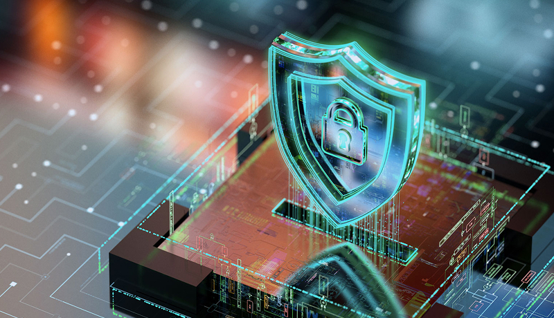 A glowing digital shield with a padlock icon hovering over an illuminated circuit board representing cybersecurity