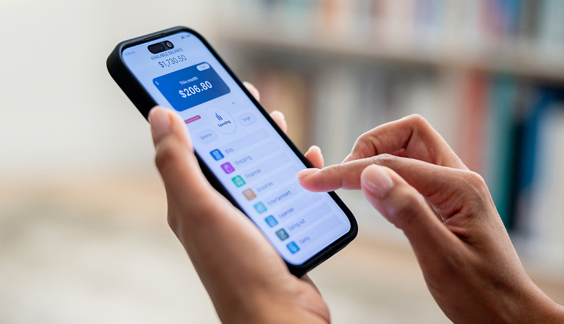 A man holding a phone and using a banking app.