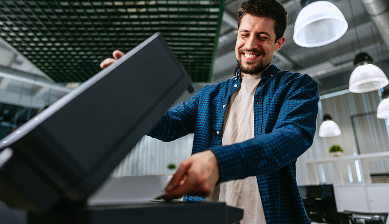 man-in-office-by-printer-person-view