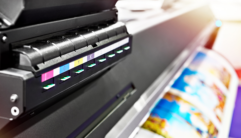 Wide format color printer in an office setting.