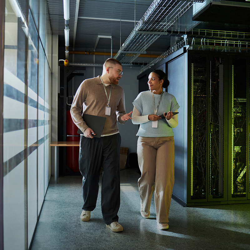 IT team members walking together through a server room.