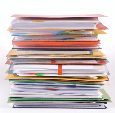 Image description: a stack of file folders filled with paper and multi-colored tabs