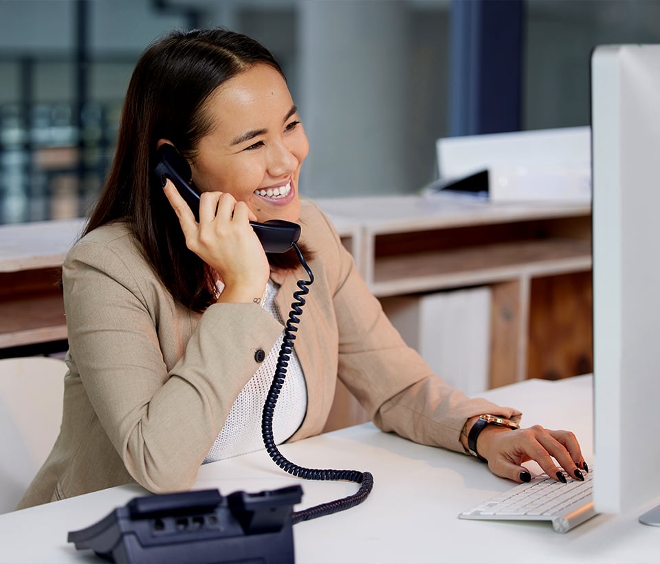 Business woman using corded phone