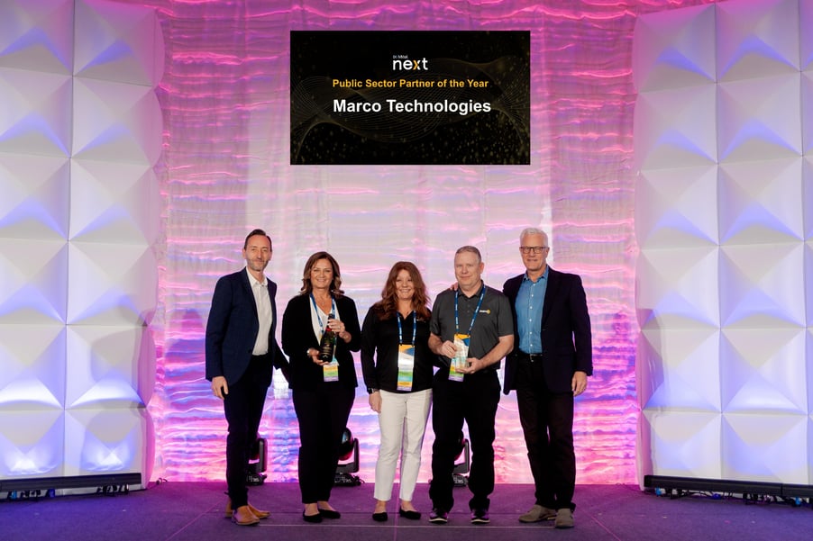 Marco Technologies employees accept Mitel's Public Sector Partner of the Year award in 2024.
