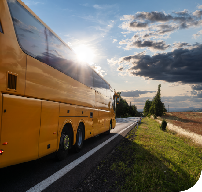 An orange bus speeds off into the sunset, celebrating RIDES' savings after adopting a managed IT solution.