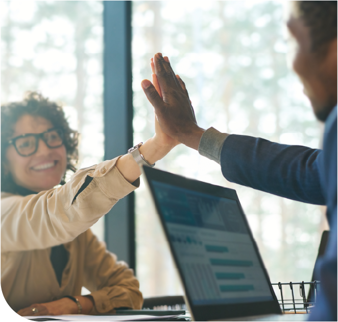 Two workers celebrate business wins achieved through Marco's managed IT.