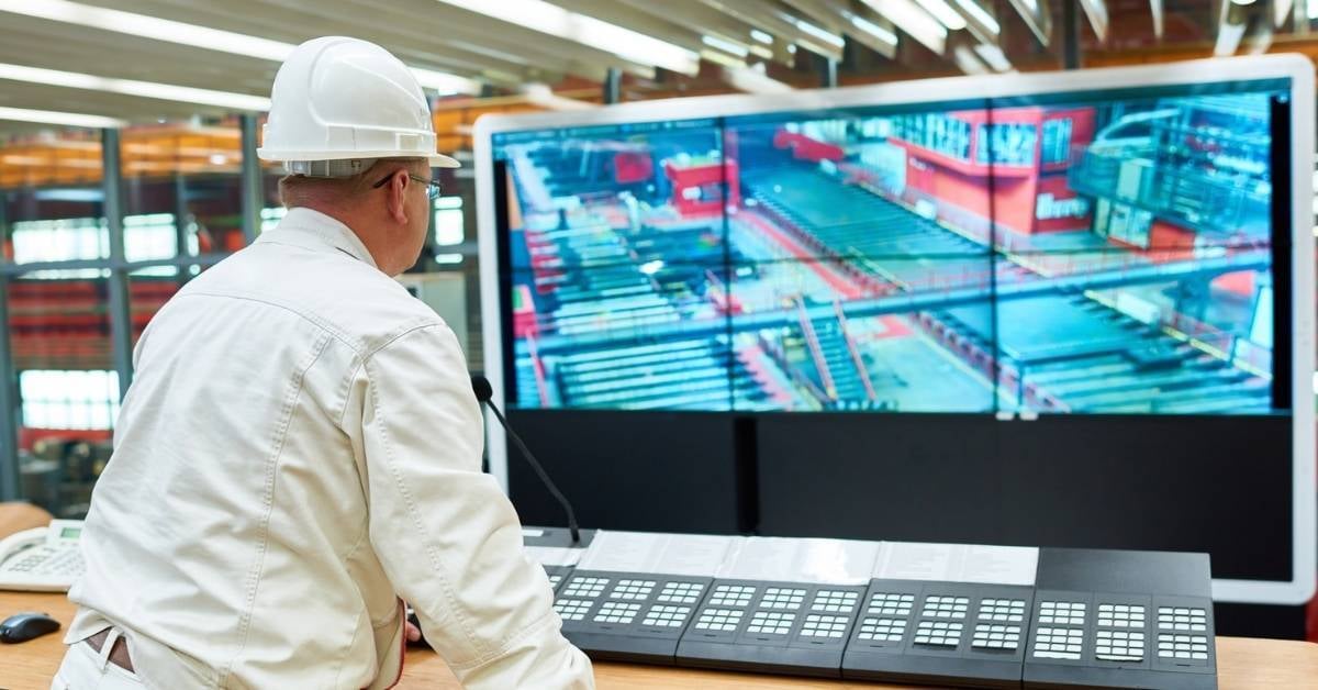 A-manufacturing-worker-oversees-the-entire-floor-through-surveillance-systems