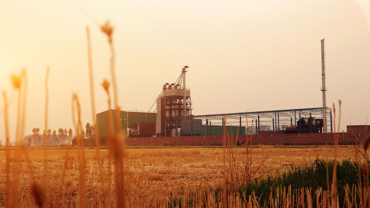 The sun rises on a rural Midwestern factory.