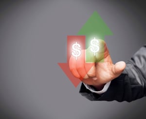 Image of a red arrow pointing down and a green arrow pointing up. Both arrows have dollar signs in them. There is a hand pointing at the green arrow from behind. 