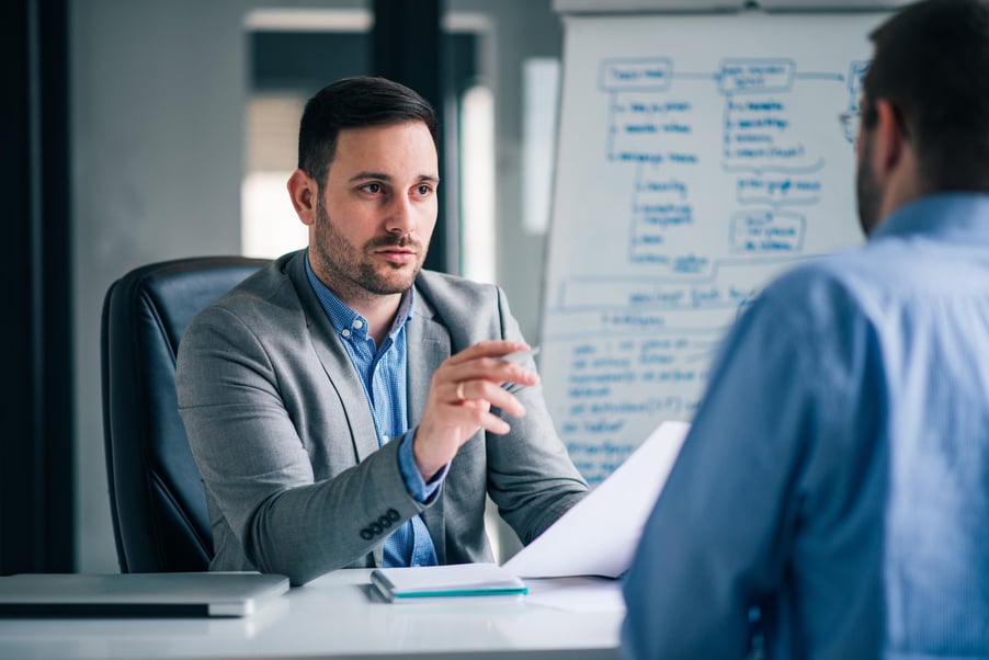 Business leadership meeting discussing IT outsourcing.